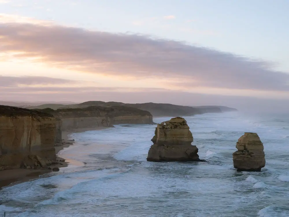 Great Ocean Road itinerary: 12 Apostles at dawn. Limestone stacks with coastal cliffs and clouds