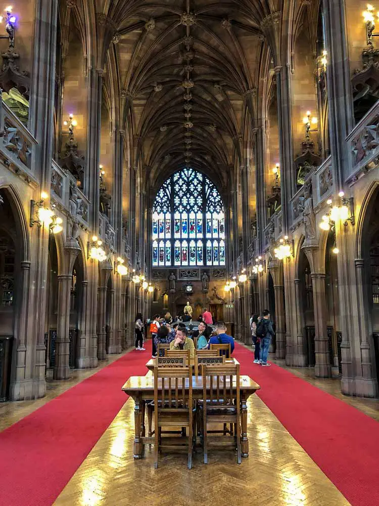 Manchester John Rylands Library. vaulted room desk chairs and red carpet